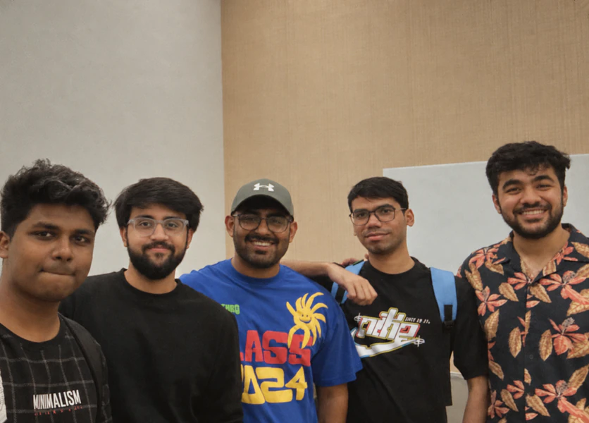 Five Bricx teammates smiling together at an offsite