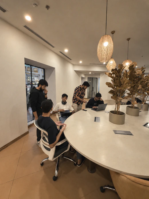 Bricx teammates at work around the office meeting table