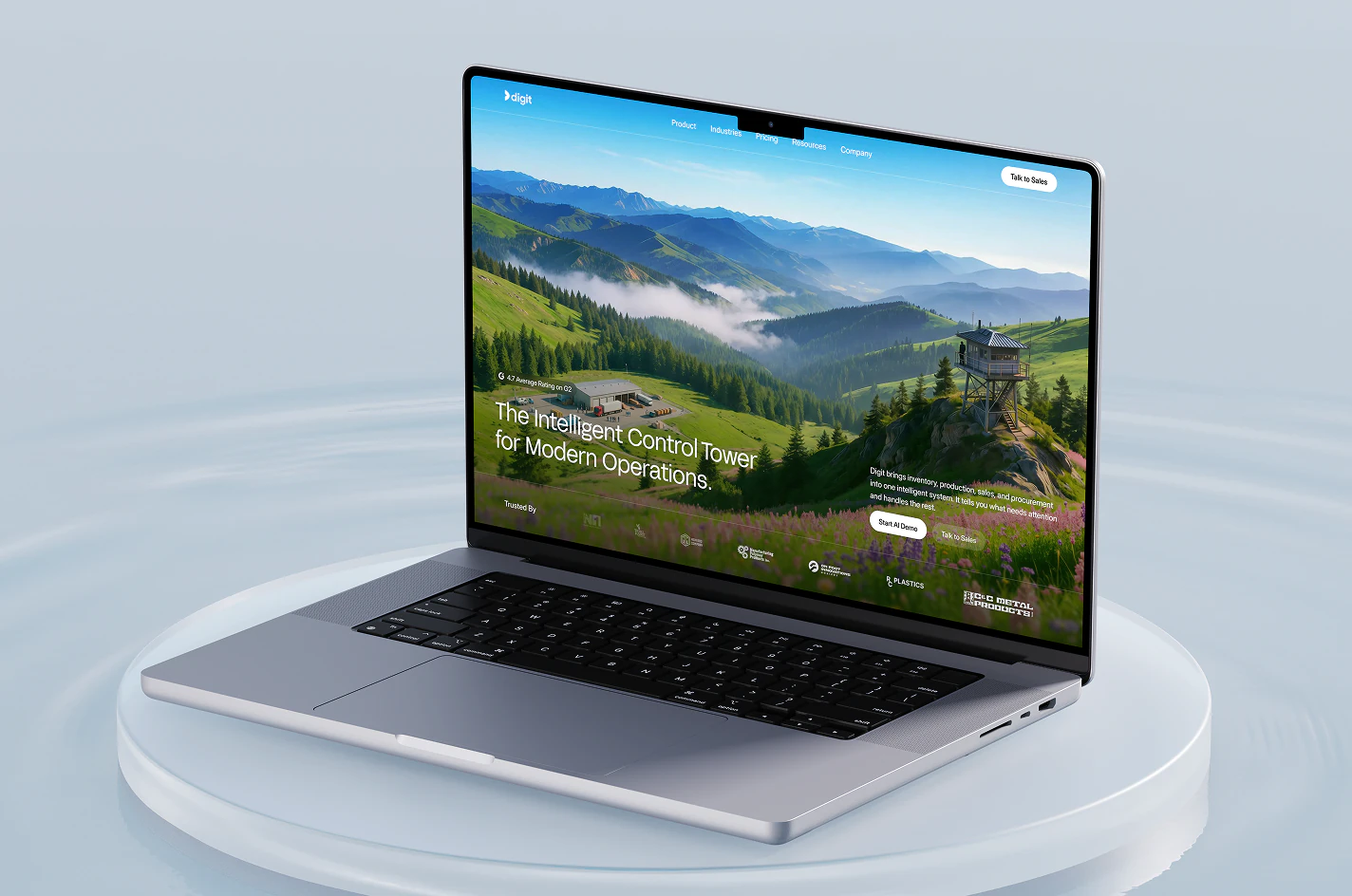 The Digit website shown on a MacBook resting on a glass plinth